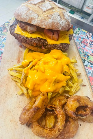  32-ounce burger with bacon and cheese, plus skin-on fries smothered in nacho cheese sauce and beer-battered onion rings