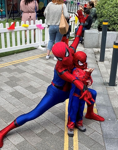 Spiderman poses with a fan