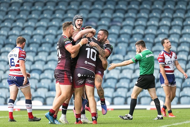 Hornets players celebrate a try against Oldham
