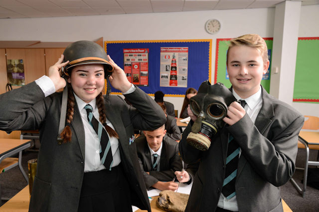 Students with a war helmet and camera