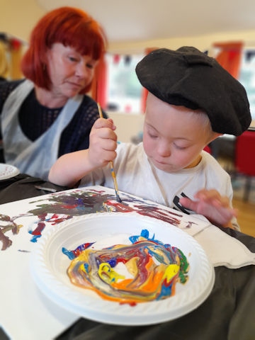 A young member tries mindfulness painting