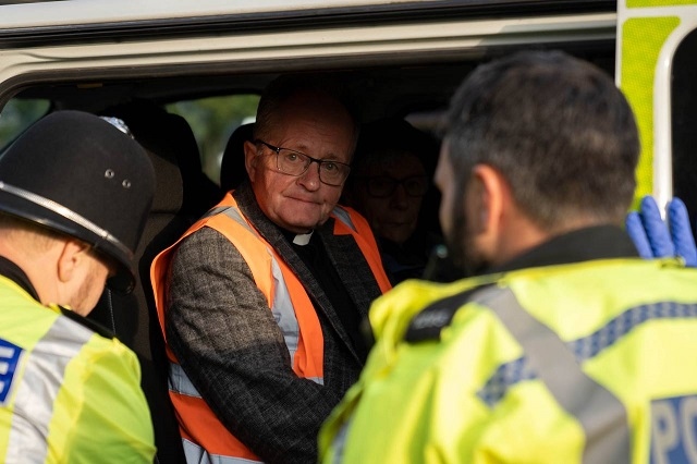 Revd Mark Coleman is arrested for sitting outside the Kingsbury Oil Terminal to demand an end to new oil and gas projects in the UK