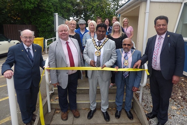 Mayor of Rochdale Councillor Ali Ahmed cuts the ribbon to officially open Hub Alkrington alongside council leader Councillor Neil Emmott, local councillors, community groups and council staff