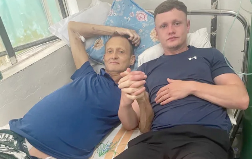Nicholas Jones, left, with son Reece in the Philippines hospital