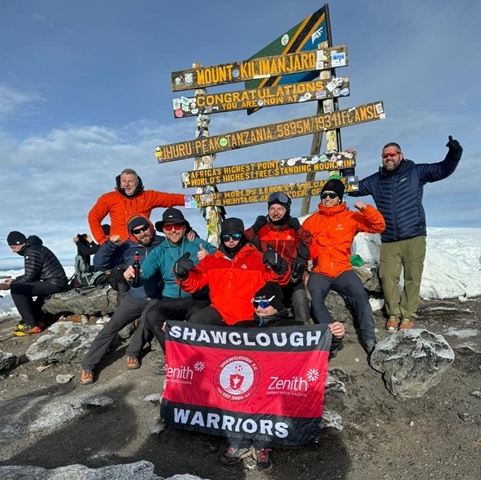 Stephen Shea, Simon Regan, James Keeling, Ryan Mathers, Patrick Altimus, John Finnerty, Lee Ashworth, and Liam Jones at the summit of Kilimanjaro