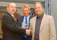 David Howles (right) receiving his award with TV presenter William Woollard (centre) looking on