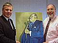 Tony Ballard-Smith (left) of the Ogden Trust being presented with the painting of Sir Cyril Smith by John Kay