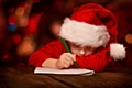 Child writing letter to Father Christmas