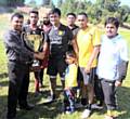 Doulat Miah, WCCA Manager, presents the trophy to the winning team, Return of Gaza FC 
