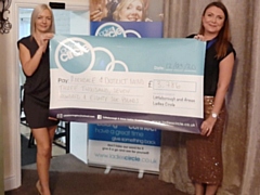 Heidi Murphy hands over the cheque to Rebecca Steele, Rochdale & District Mind CEO (Including Bury & N.E. Lancs)