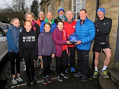 Ruby Fort presenting John Calvert with an award for services to athletics at the Ian Holloway 5k