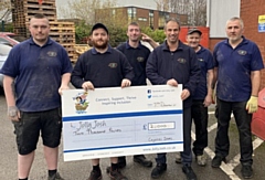 Richard Hagan (third right) with staff from Crystal Doors and their cheque for Jolly Josh