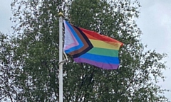 The Progress flag flying in the Pennines: it features trans colours on the traditional rainbow background alongside a black and brown stripe, both representing�marginalised people of colour in the LGBTQ+ community