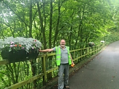 Volunteer Phil Starr with one of the saddle planters on School Lane