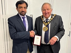 Mike Holly, the Mayor of Rochdale, presents a shield to Syed Imran Haider, outgoing NADRA manager of the Pakistan Consulate in Manchester