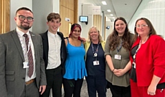 Councillor Danny Meredith (far left of the photo) and Councillor Rachel Massey (far right of the photo) with young people who have experienced care and council officers from the children’s services department