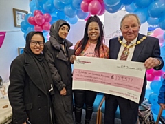 Nicky Iginla (second right), CEO and founder of Caring and Sharing Rochdale receiving a cheque from the National Lottery Community Fund in 2023