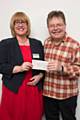 Littleborough Arts Festival Chairman, Richard Cafiero presenting a cheque to Julie Halliwell from Springhill Hospice
